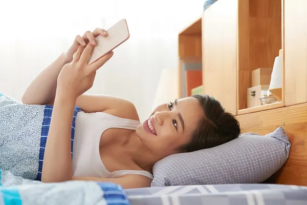 Khuôn mặt nằm xem điện thoại cười ngộ nghĩnh. Khuôn mặt nằm xem điện thoại cười ngộ nghĩnh.