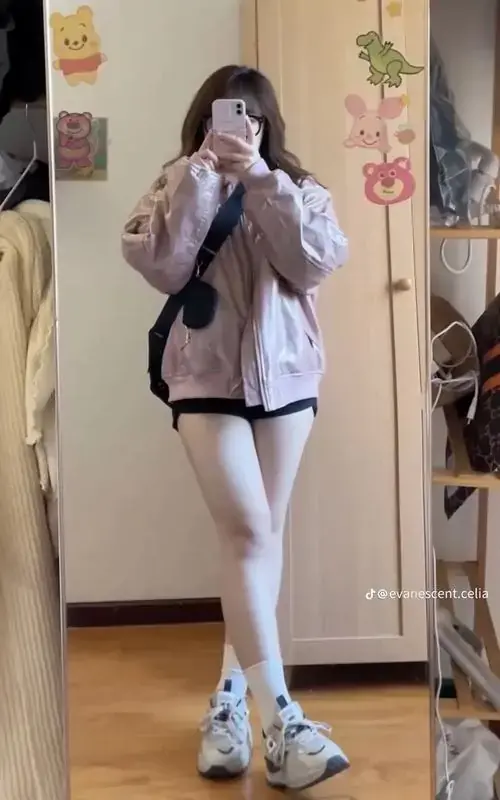 15 Trong phòng nhiều sticker, cô nàng mủm mỉm cầm điện thoại selfie, áo trắng phối quần ngắn